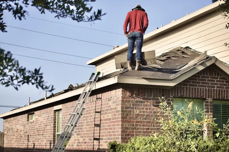 Professional roofer working on a residential roof in West Columbia